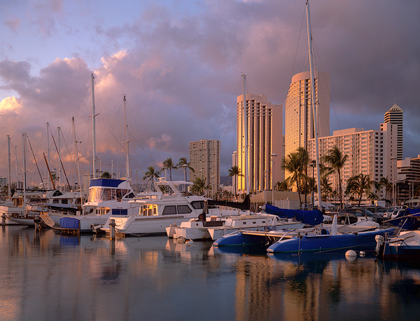 Late afternoon sun reflects off boats docked at Ala Wai Small Boat Harbor